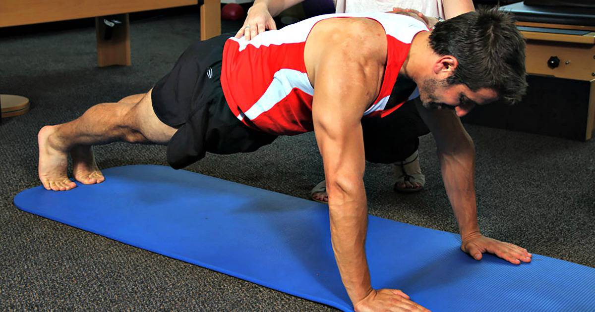 Man in sports clothes doing pushup