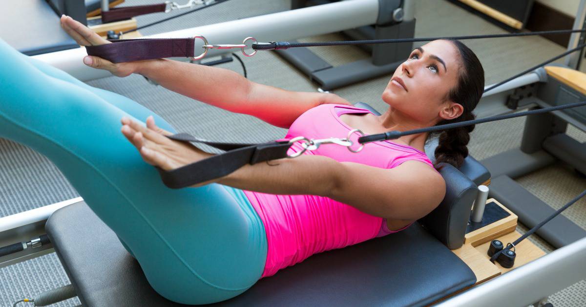 Attractive woman on Pilates Reformer